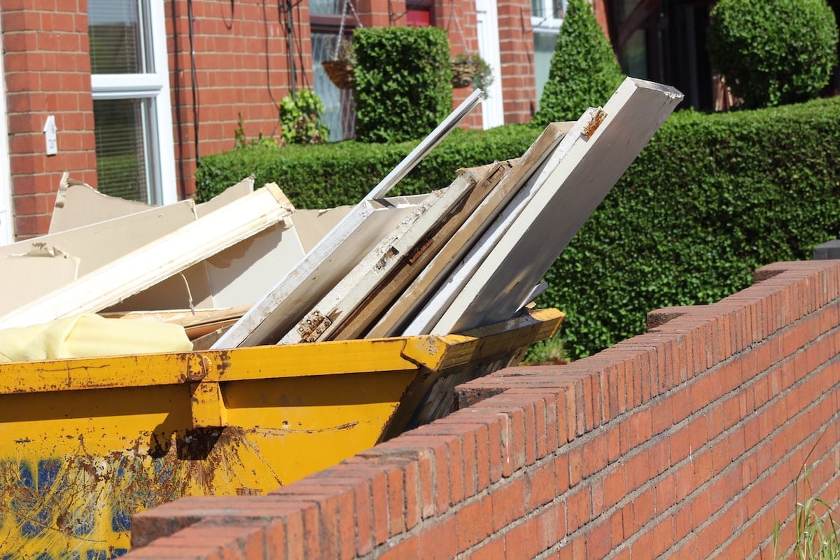 Yellow Skip with plasterboard and other waste inside